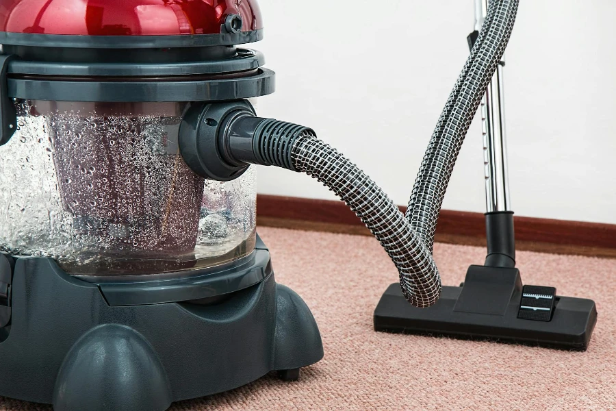 Black and Red Canister Steam Cleaner on Floor