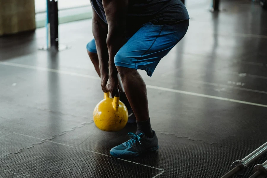 Person Using Yellow Kettlebell