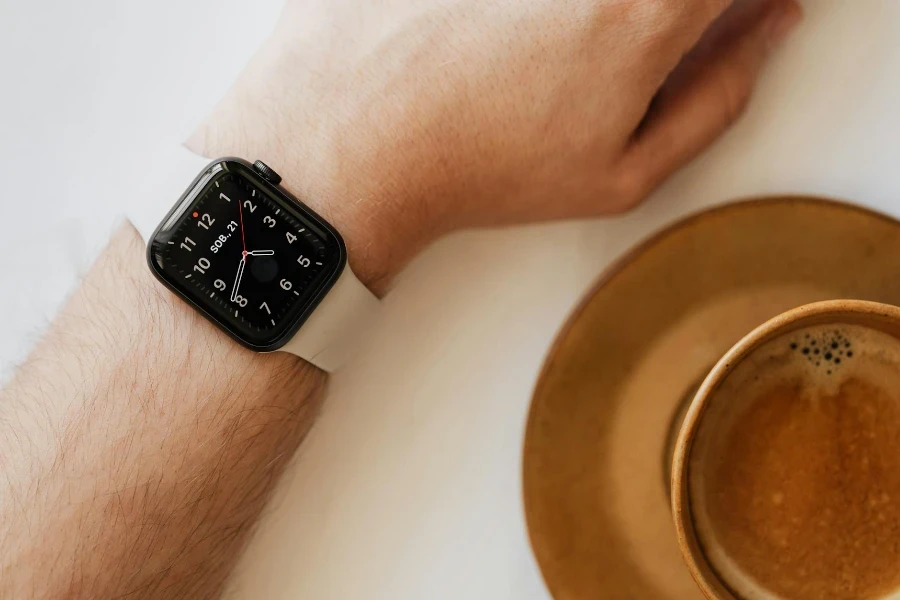 Smart watch on wrist of man drinking coffee