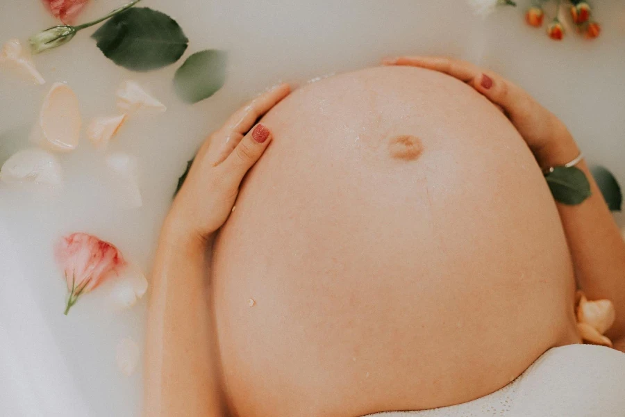 Pregnant Woman Sitting on Bathtub