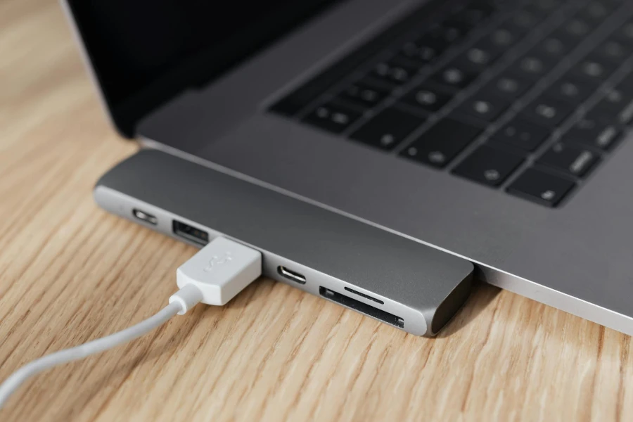 High angle of modern space silver laptop with USB type c multiport hub