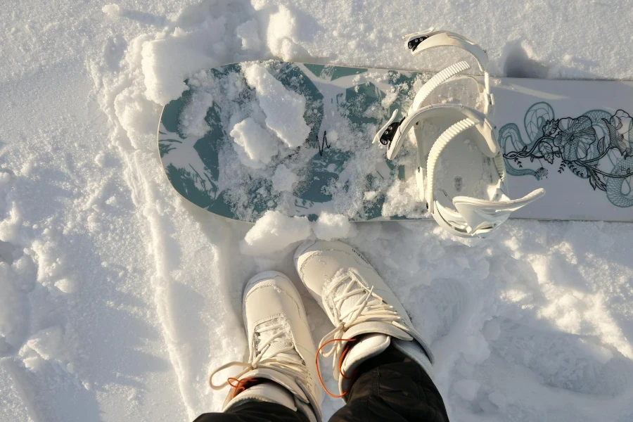 Une personne en pantalon noir et chaussures blanches