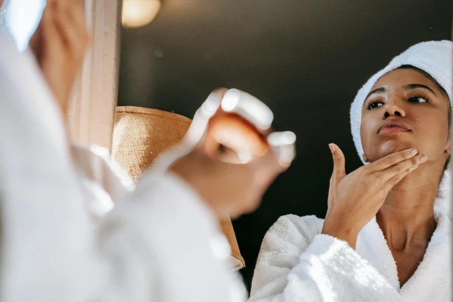 a woman is applying CC cream