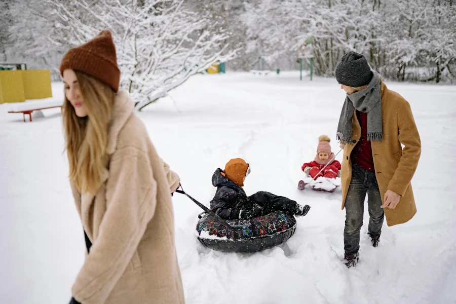 A Couple Pulling Snow Tubes