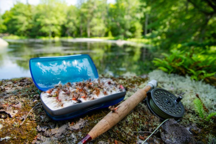 Medium lure wallet sitting on ground next to water