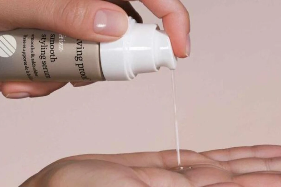Person pouring hair serum into hands