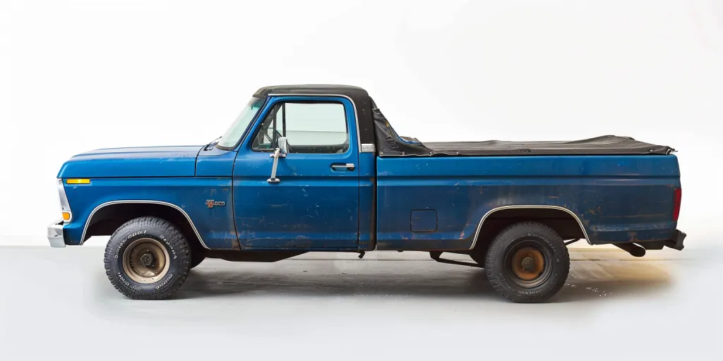 photo of blue truck with black tonneau cover on bed