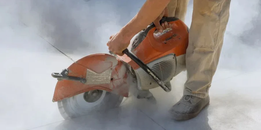 Diamond blade saws are used by construction workers to cut concrete sidewalk