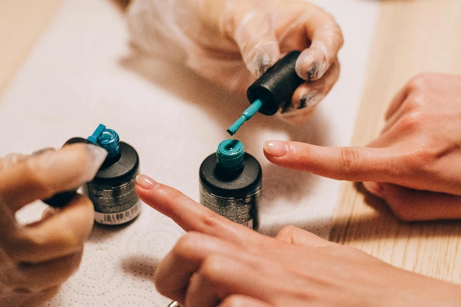 A Manicurist Holding Nail Brushes