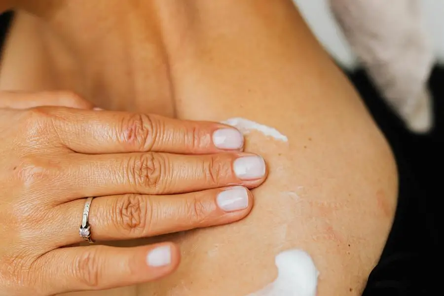 A Person Applying Lotion Cream on the Skin by Karolina Kaboompics