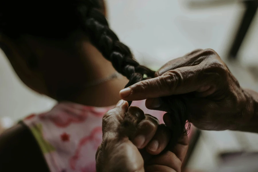 A Person Braiding Hair