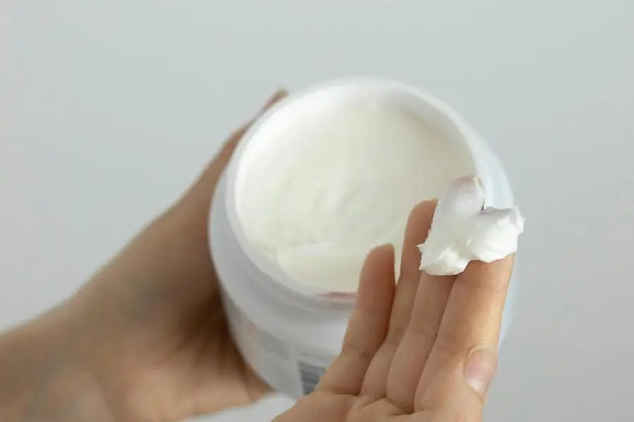 A Person Holding White Cream in White Plastic Container by Mike Murray