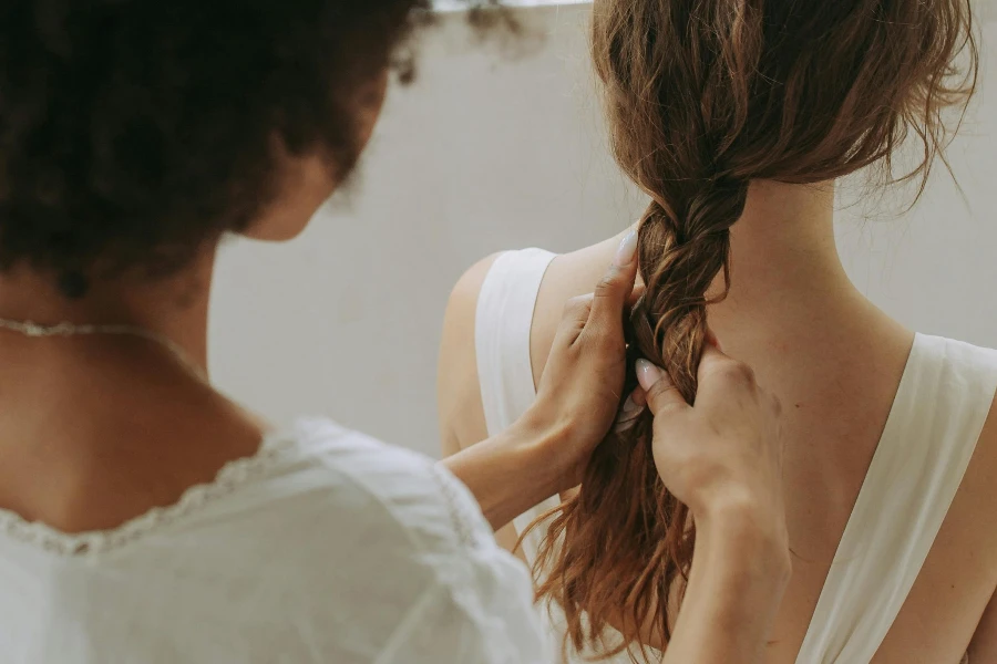 A Woman Braiding a Hair