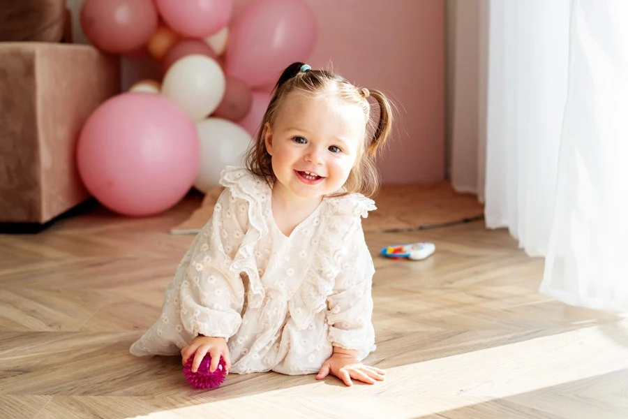 A baby girl in wearings in neutral colors