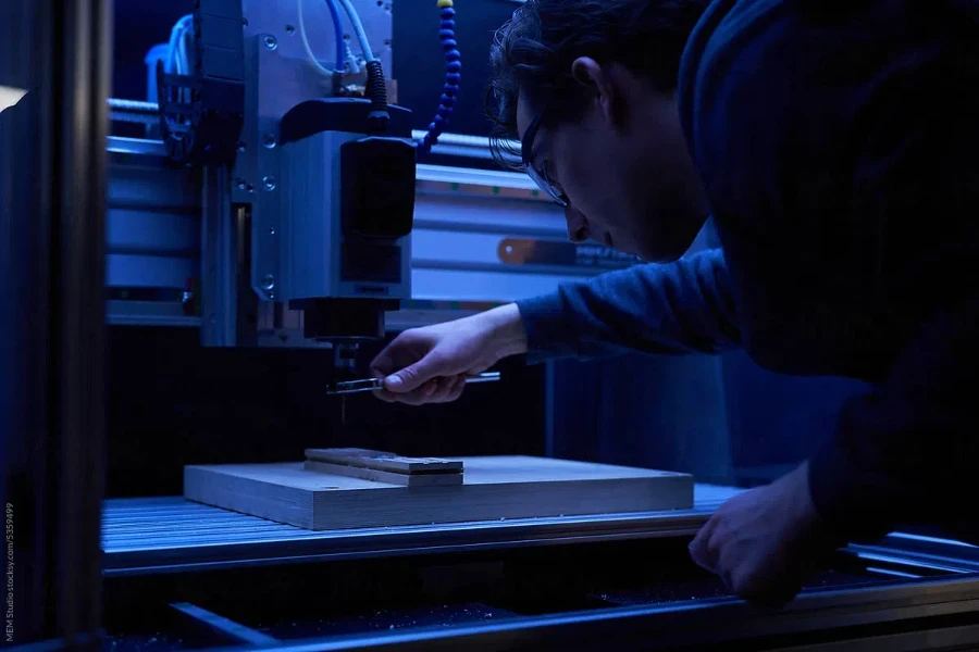 Ein Handwerker bohrt Holz mit einer CNC-Maschine