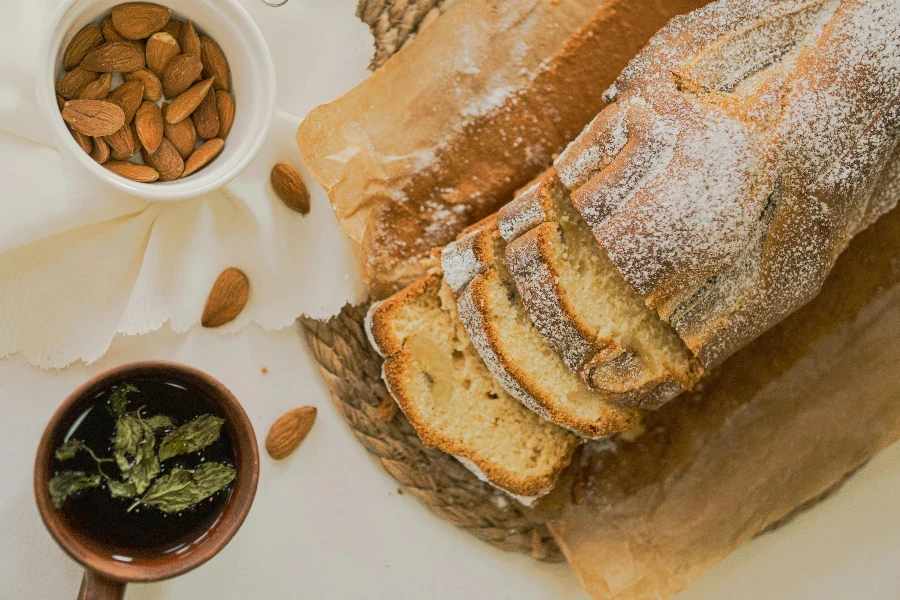 A loaf of bread with almonds and a cup of coffee