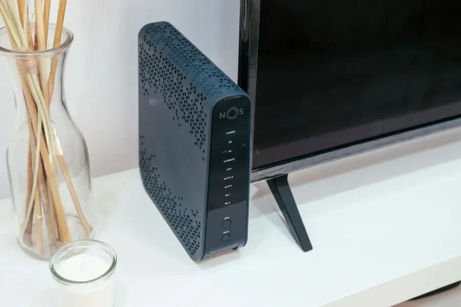 A sleek home technology setup featuring a router, glass decoration, and television