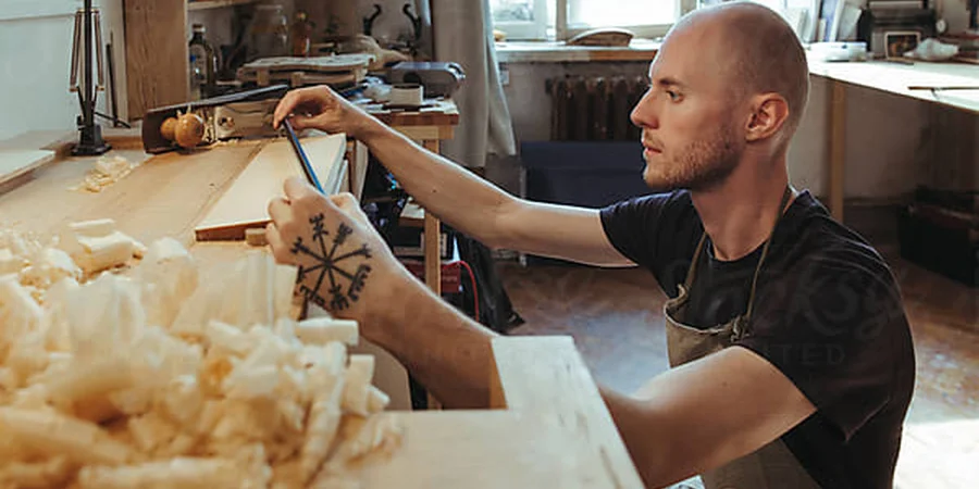 A violin artisan in his workshop by Irina Polonina on Stocksy (Stocksy Content License)