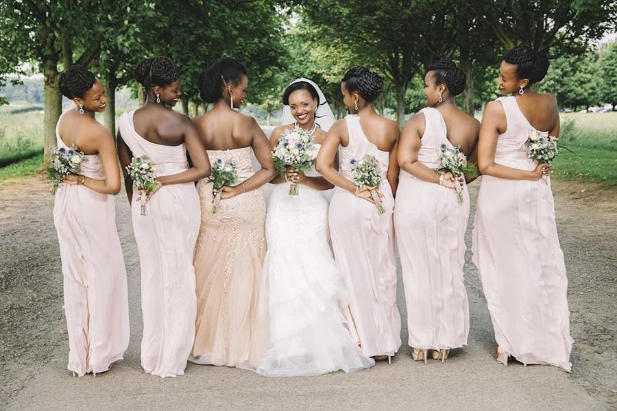 Bridal party with pink ruffled bridesmaids dresses