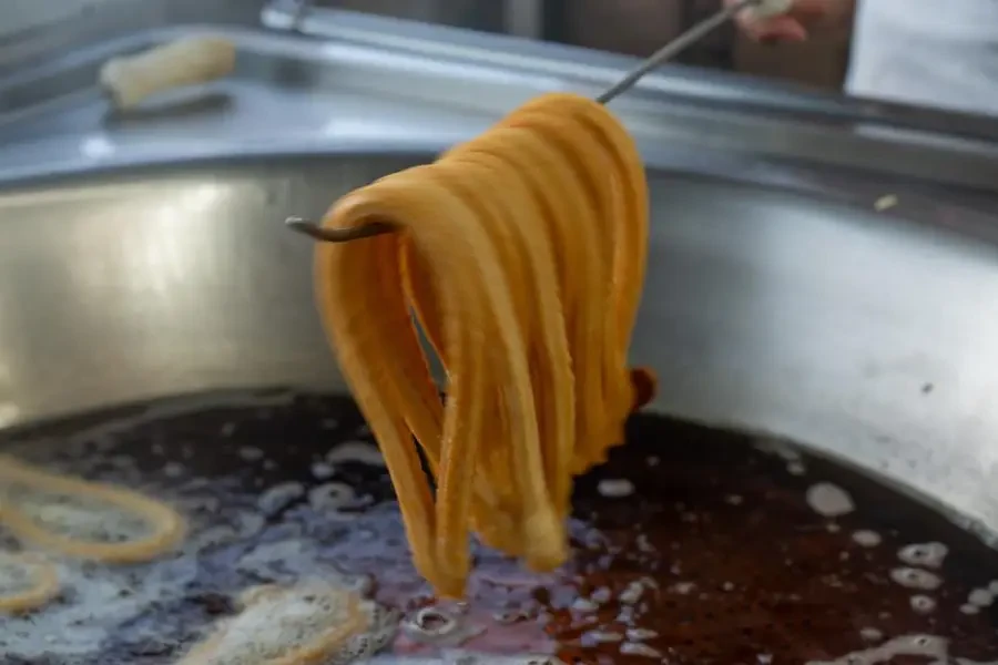 Churro maker machines operate through a straightforward yet ingenious mechanism