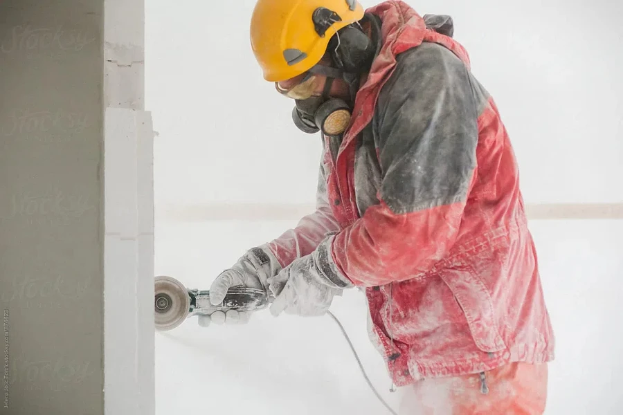 Construction Worker Cuts With An Electric Grinder