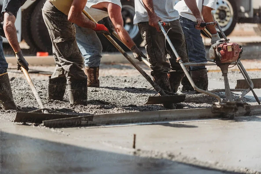 Construction workers pouring a concrete slab