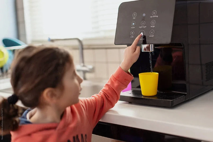 Cute kid using a water filter machine