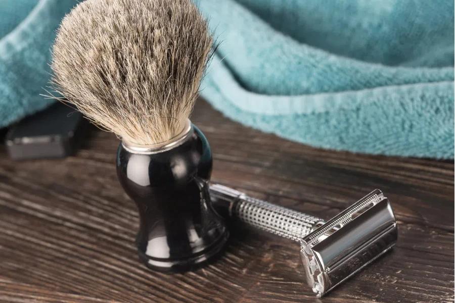 Double edged razor in bathroom setting prepared for a wet shave with a badger hair shaving brush and towel