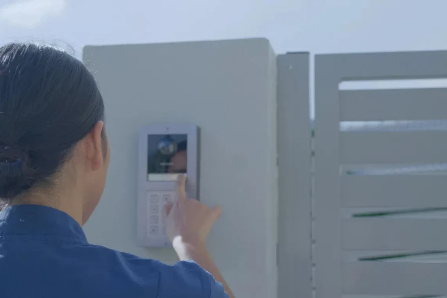 Healthcare worker pushing smart doorbell