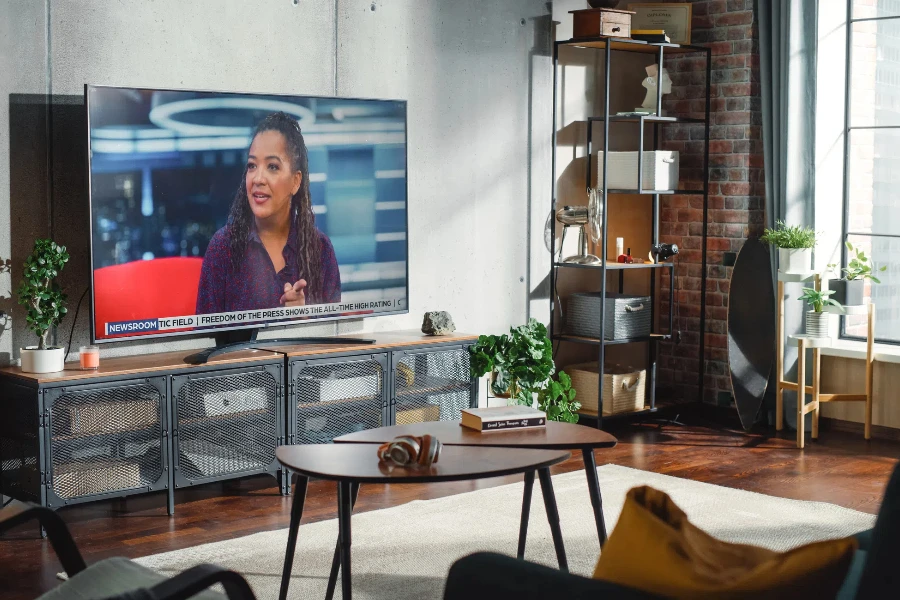 Living Room Television Showing TV News Programme with Two Presenters Talking and Joking on TV