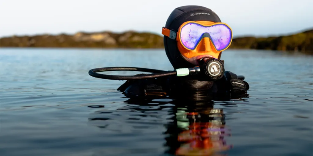 Man floating while wearing a single lens mask