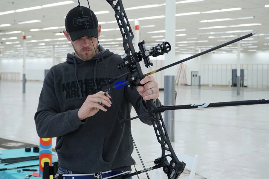 Man holding a black composite bow