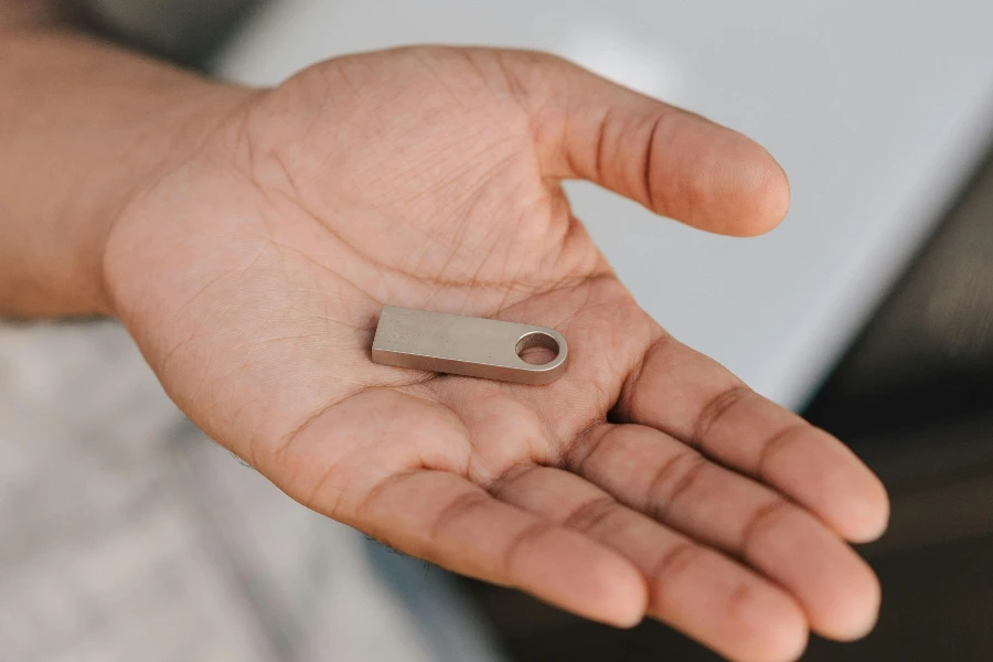 Man holding flash drive containing digital information