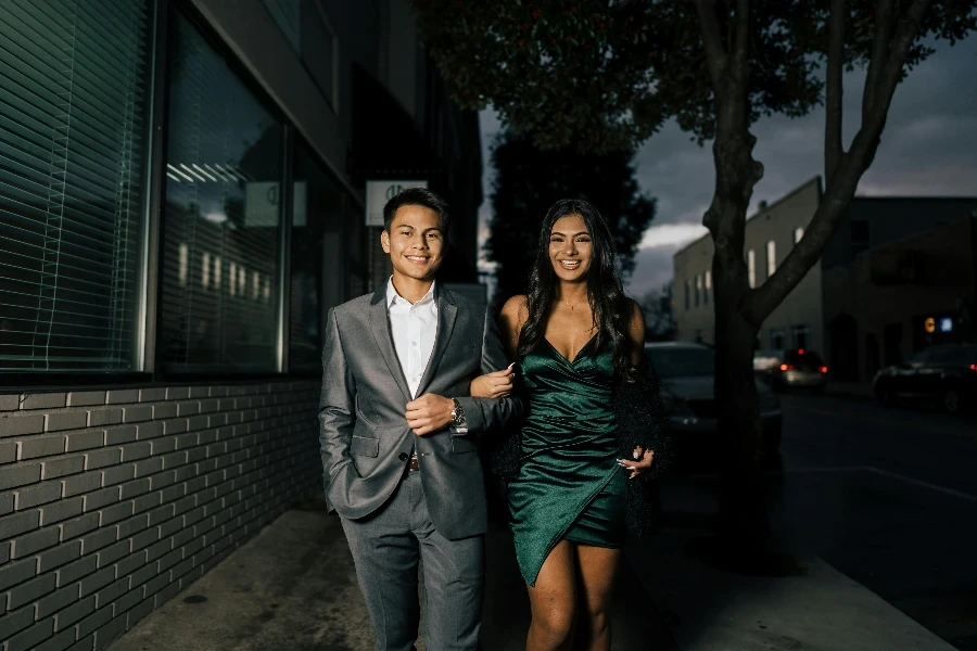 Hombre de traje gris de pie junto a una mujer vestida de verde por Juan Vargas