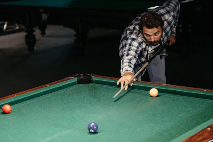 Man lining up an impressive shot with a standard cue