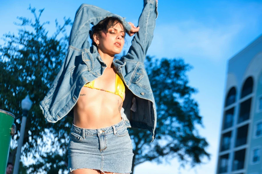 Model Posing in Jean Jacket, Skirt and Boots