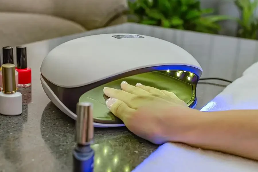 Nail polish is placed next to the UV nail lamp