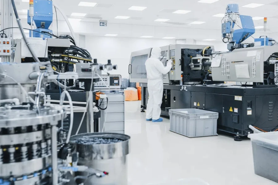 On a Factory Scientist in Sterile Protective Clothing Work on a Modern Industrial 3D Printing Machinery