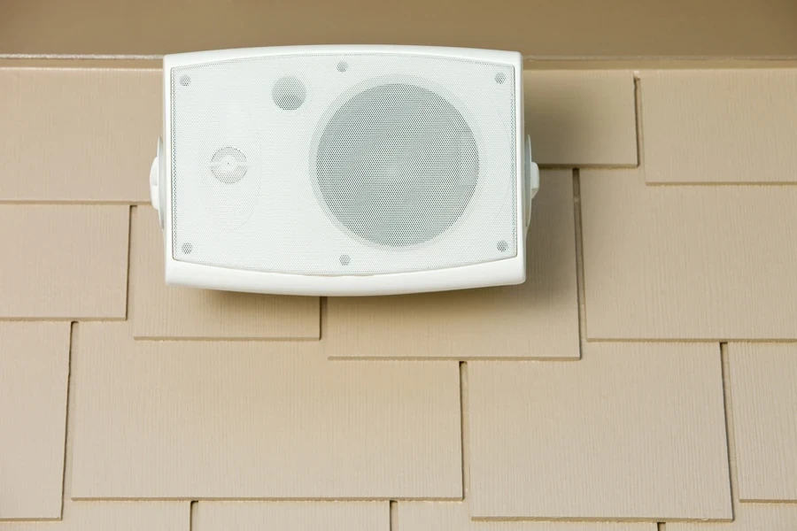 Outdoor speaker mounted on house siding