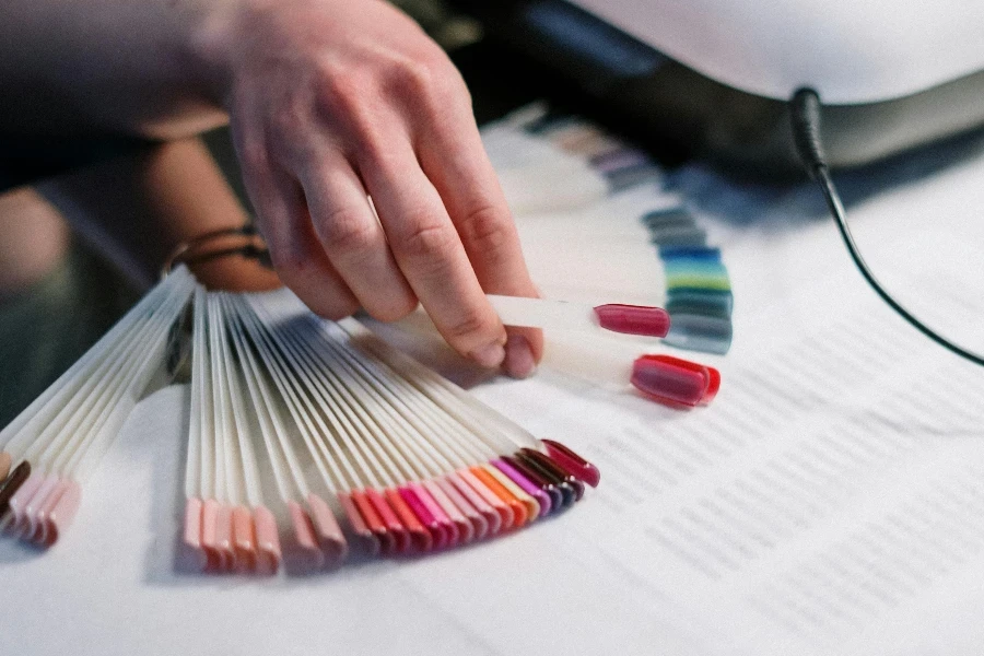 Person Holding Artificial Nail Samples