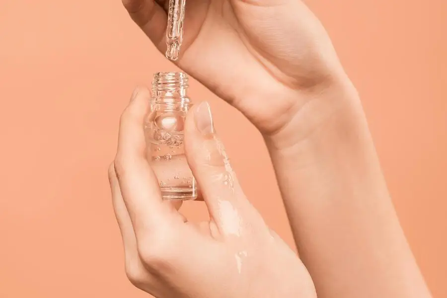 Person Holding Serum Bottle by Shiny Diamond