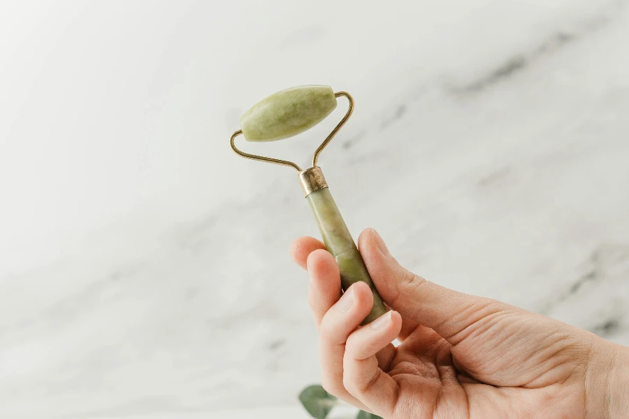 Person Holding Silver Spoon With White Flower Petals by cottonbro studio