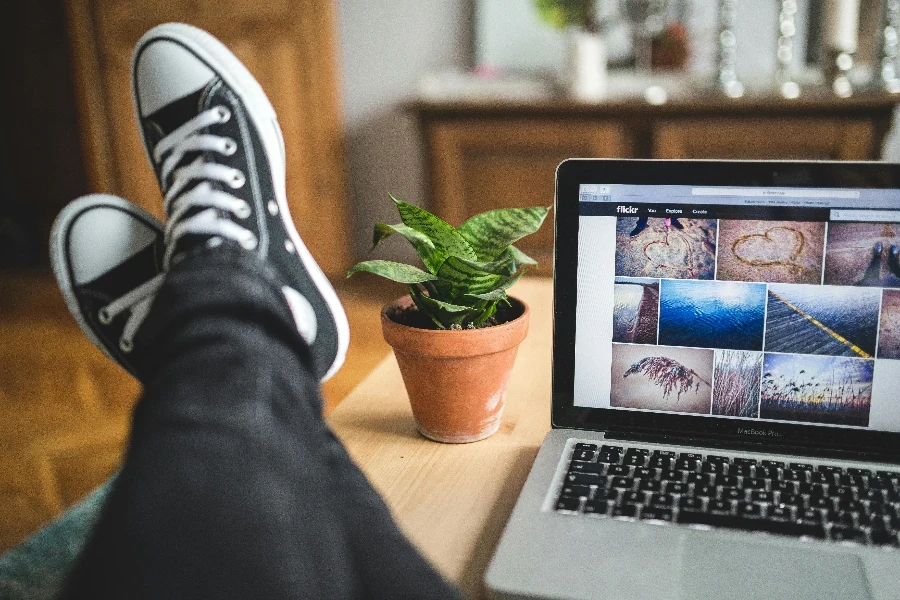 Person with Legs Resting on Wooden Desk