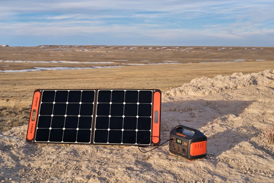 Portable Power Station, is being charged by a solar panel in a remote location in Pawnee National Grassland, early spring scenery