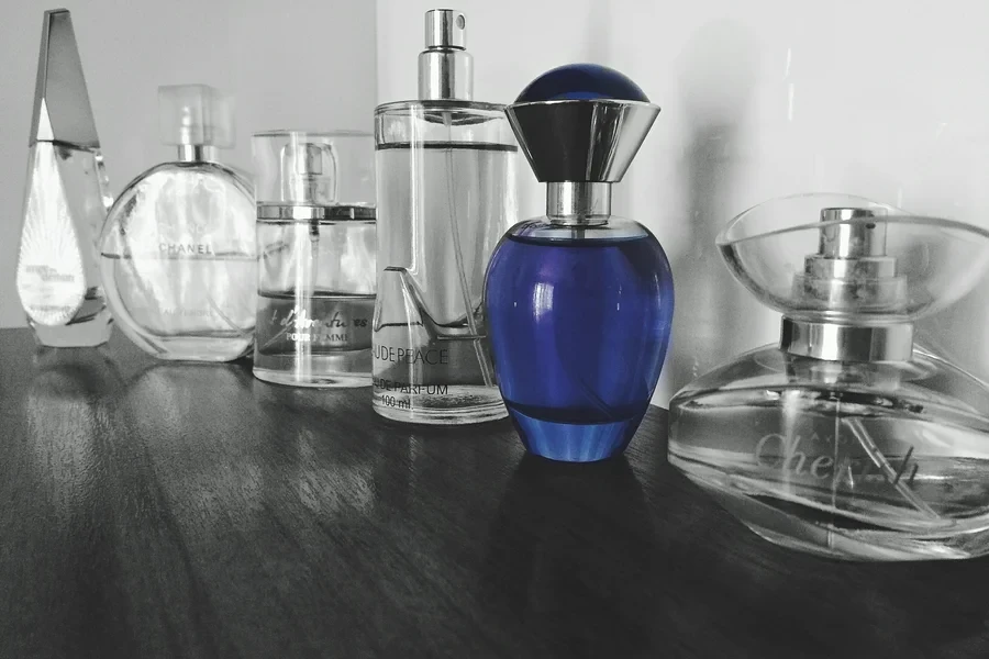 Selective Focus Photography of Blue Fragrance Bottles on Table by Uva Rova