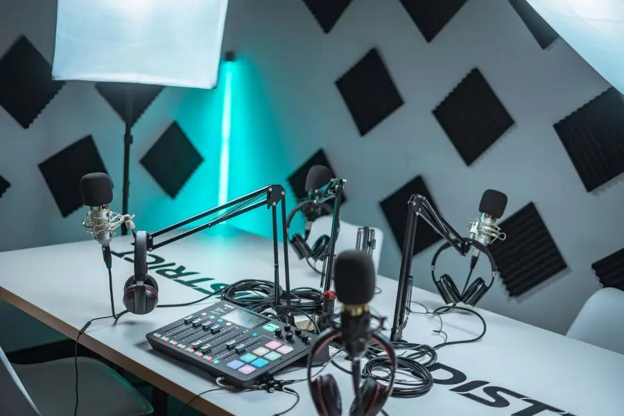 Sleek podcast studio setup featuring microphones, audio mixer, and acoustic panels