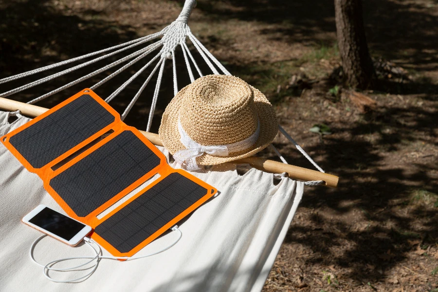 Smartphone is charging from solar battery in summer camp