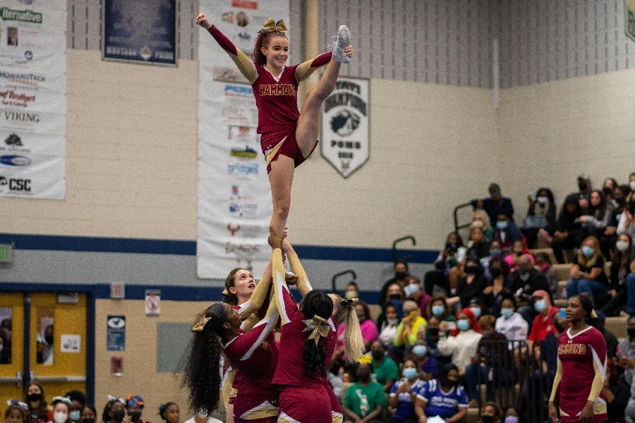 Squad of Cheerleaders Doing a Stunt