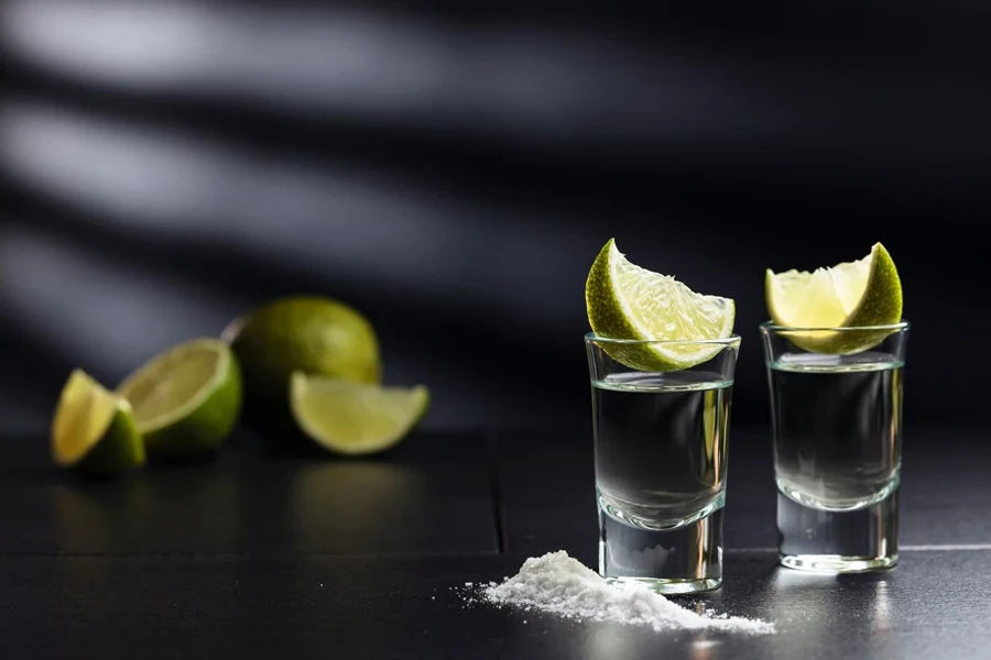 Tequila , lime and salt on black table