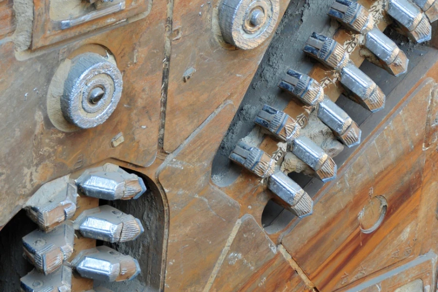 Tunnel Boring Machine head with worn-out parts ready to be extracted from finished underground tunnel